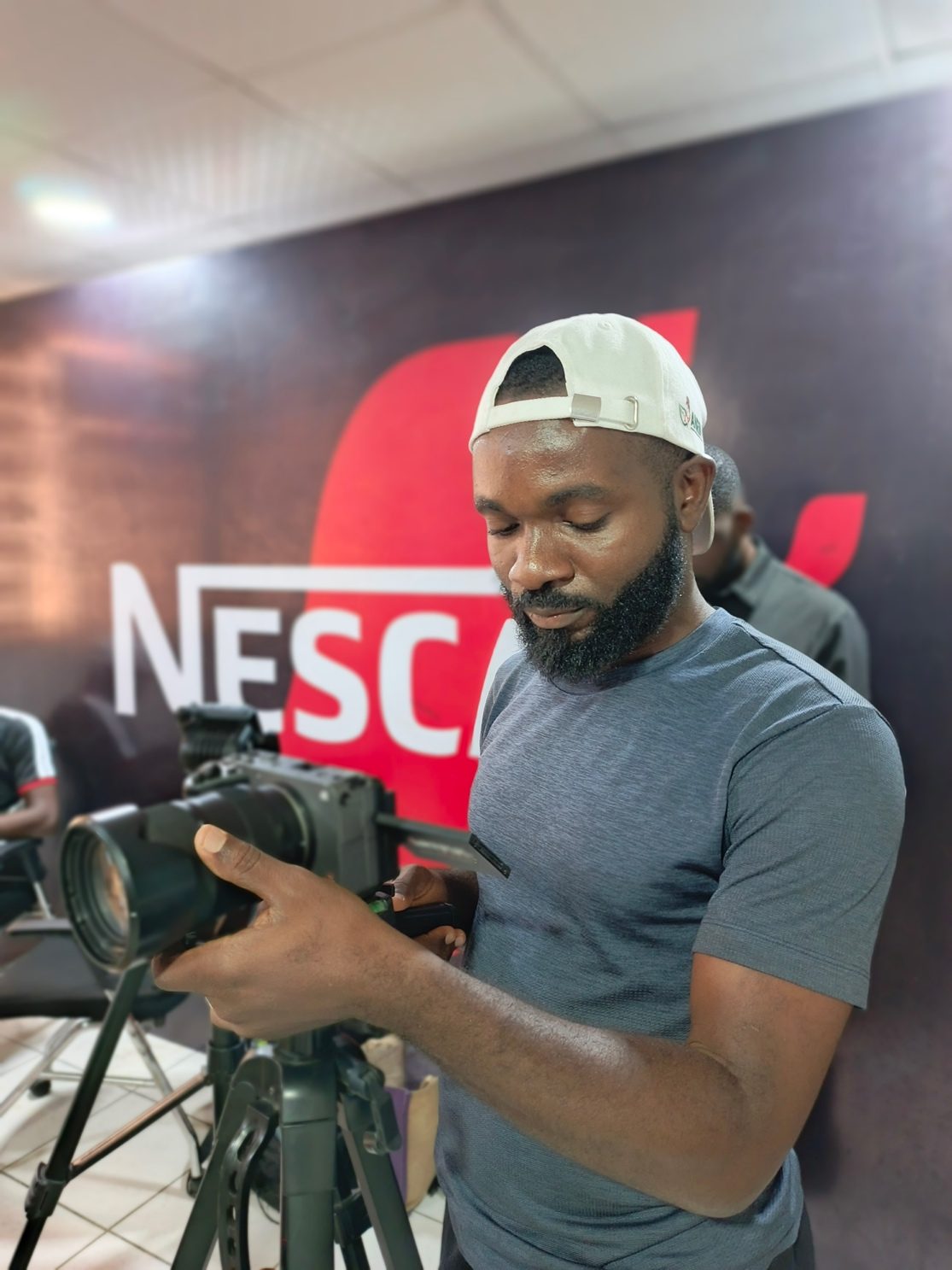 A Thirteenth MediaTech videographer operating a camera on set